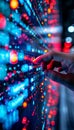 Close-up of a hand interacting with a futuristic digital interface with glowing red and blue lights Royalty Free Stock Photo