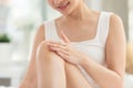 Close up hand on knee Asian young woman apply cream or lotion on her knee for protect dry skin for moisturizing on skin. Healthy Royalty Free Stock Photo