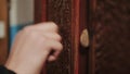 Close-up of hand knocking on door