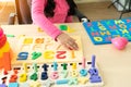 Close up hand of Little children playing with alphabet numbers puzzle Royalty Free Stock Photo