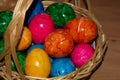 Close-up of hand-made colored easter eggs in wicker basket ready to eat Royalty Free Stock Photo