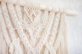 Close-up of hand made macrame texture pattern. ECO friendly modern knitting DIY natural decoration concept in the interior. Flat