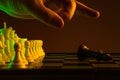 Close-up hand makes a move, check and checkmate, chess, chessboard, game, confrontation. career, promotion, startup crisis
