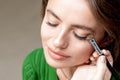 Makeup artist applies eyeshadow on eyes Royalty Free Stock Photo