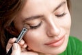 Makeup artist applies eyeshadow on eyes Royalty Free Stock Photo