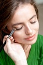 Makeup artist applies eyeshadow on eyes Royalty Free Stock Photo
