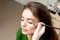 Makeup artist applies eyeshadow on eyes Royalty Free Stock Photo