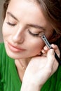 Makeup artist applies eyeshadow on eyes Royalty Free Stock Photo