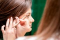 Makeup artist applying eyeshadow on eye Royalty Free Stock Photo