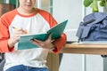 Close up hand of male teenager writing with pencil on notebook a Royalty Free Stock Photo