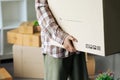 Close up of hand a man carrying box for moving into new apartment. relocation move home concept