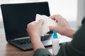 Close up hand a man cleaning and disinfection of workspace. Disinfecting wipes to wipe surface of desk