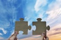 Close up hand of man connecting jigsaw puzzle with blue sky background Royalty Free Stock Photo