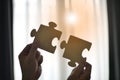 Close up hand of man connecting jigsaw puzzle with sunlight effect Royalty Free Stock Photo