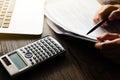 Close up of Hand man doing finances and calculate on desk about cost at home office.Savings, finances and economy concept. Royalty Free Stock Photo