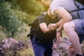 Close up of hand man getting help to bestfriends climb a rock,Helping hands,Overcoming obstacle concept Royalty Free Stock Photo