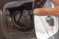 Close up hand man open the fuel tank cover in the car Royalty Free Stock Photo