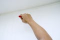 Hand of man painting wall using paint brush Royalty Free Stock Photo