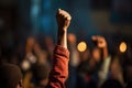 Close up of a hand of a man raising his fist at a concert, A raised fist of a protestor at a political demonstration, AI Generated