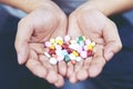 Close up hand man taking multiple colors pills in hand. Royalty Free Stock Photo