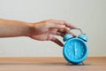 Close up of hand of man turns off the alarm clock. Royalty Free Stock Photo