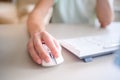 Close up hand man using mouse and computer at home with morning light Royalty Free Stock Photo