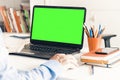 Close-up of hand man using a mouse and typing on green screen laptop on white table, business concept Royalty Free Stock Photo