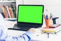 Close-up of hand man using a mouse and typing on green screen laptop on white table, business concept Royalty Free Stock Photo