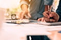 Close up hand man writing make note on notebook and hand pointin Royalty Free Stock Photo