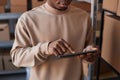 Close-up of hand of manager pointing at tablet screen while entering data