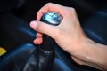 Close up of hand on manual gear shift knob