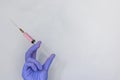 Close up hand in medical gloves holding syringe isolated on white background with copy space. Medicine and vaccination concept Royalty Free Stock Photo