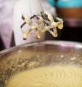 Close up of hand mixer beaters with dripping cake mix Royalty Free Stock Photo