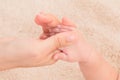 Close up of hand mother holding tiny finger adorable infant with love and care while sleeping. Newborn baby deepy sleeping on soft Royalty Free Stock Photo