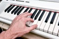 Close-up of the hand of a musical artist playing the piano, a man`s hand, classical music, keyboard, synthesizer, pianist Royalty Free Stock Photo