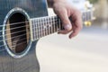 Close up hand musician playing acoustic guitar