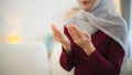 Close up hand. Muslim Islam woman with hijab do a day pray that show her believe in god. Muslim women praying in the living room