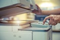 Close up hand office man press copy button on panel to using the copier or photocopier machine for scanning Royalty Free Stock Photo