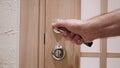 Close Up of Hand Opening the Door of House Royalty Free Stock Photo