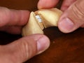 close up of a hand opening fortune cookie with message on wooden table Royalty Free Stock Photo