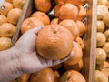 Close up Hand and Oranges in market.mandarin oranges raw Fruit,Fresh mandarin oranges texture Royalty Free Stock Photo