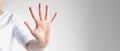 Close-up of a hand palm showing five fingers; the hand signs telling to stop and warning to do not do something Royalty Free Stock Photo