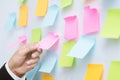 Close up hand people business man post it notes in the wall at meeting room. Royalty Free Stock Photo