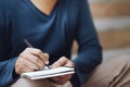 Close up hand people man are sitting on a staircase. using pen writing Record Lecture note pad into the book in park public. Royalty Free Stock Photo