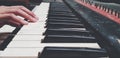 Close up hand of people playing piano or press elect tone keyboard in vintage color style Royalty Free Stock Photo