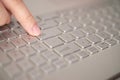Close up of hand person finger click enter button on laptop keyboard