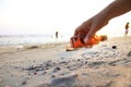 Close up hand pick glass Bottle on the beach Royalty Free Stock Photo