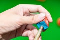 Close up hand player snooker using chalk rubbing a cue