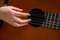 Close up of hand playing acoustic guitar. Practicing classic musical instrument. Home school education Royalty Free Stock Photo