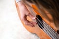 Close up of hand playing acoustic guitar. Practicing classic musical instrument. Home school education Royalty Free Stock Photo